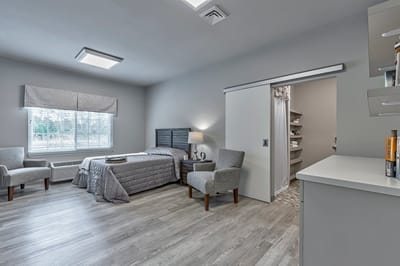 A well-furnished private resident room in a senior living facility