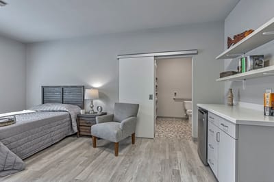 Cozy private room with a bed and chair