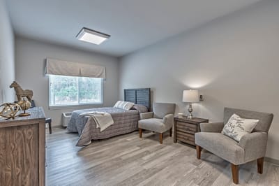 Cozy resident room with a bed and seating area