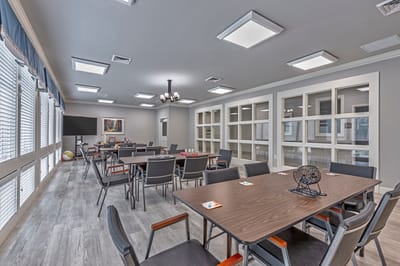 Interior view of a common area activity room with tables