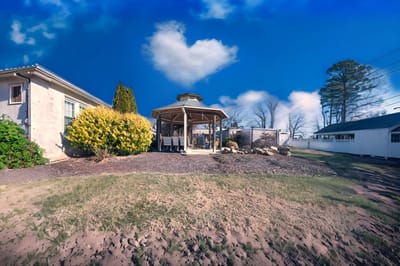 Outdoor gazebo area with colorful landscaping