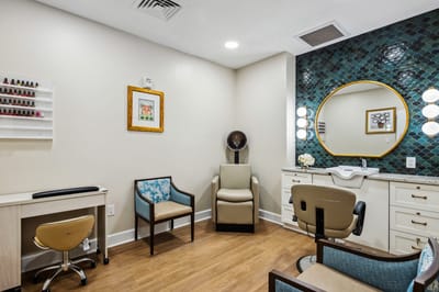 Brightly lit hair salon area with styling stations