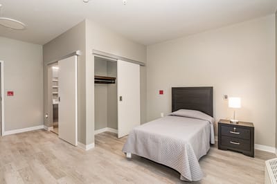 Well-furnished room with a bed and closet