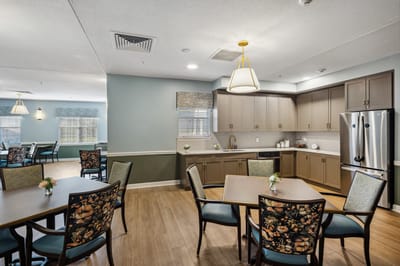 Bright dining area with tables and chairs set up