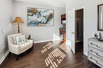 Cozy interior of a resident room with a lamp and artwork
