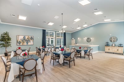 Bright dining room with tables set for meals