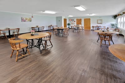 Interior view of a dining area with wooden tables and chairs