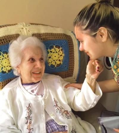 A resident engaging with a staff member in a warm interaction