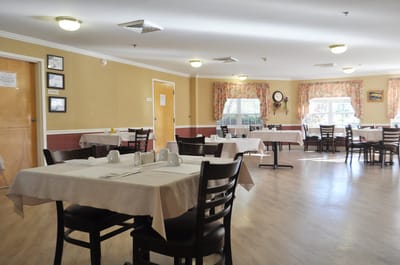 Dining room with tables set for residents