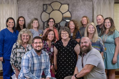 Staff members posing together in a communal area