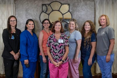 Staff members posing in a bright common area