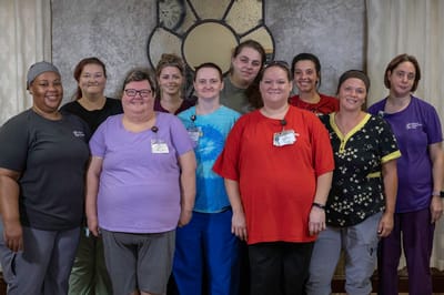 Group photo of staff members in a common area
