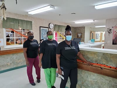 Staff members in uniforms at the facility's interior