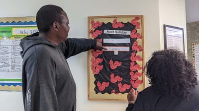 Residents engaging with an activity board in a common area