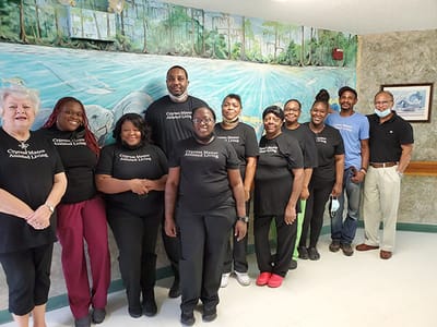 Staff members posing in a hallway