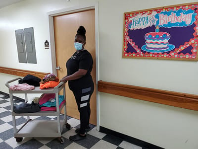 Staff member with a cart in a hallway