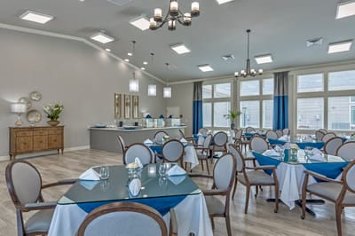 Elegant dining room setup with blue accents and large windows