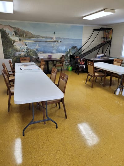 Bright activity room with tables and chairs