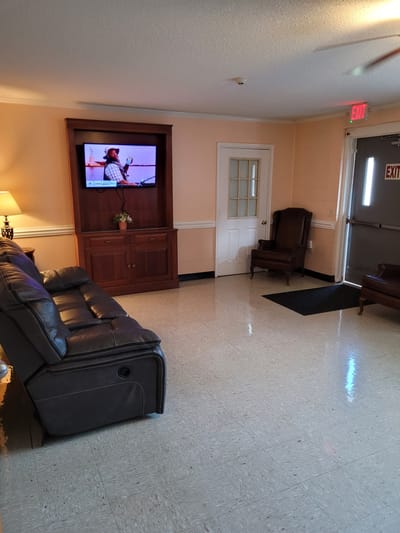 Interior view of a lounge area with seating and a TV