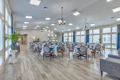 Bright dining room with tables set for meals