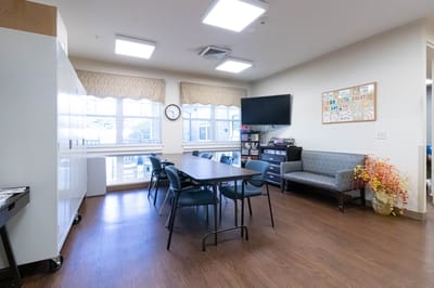 Bright common area with a dining table and seating