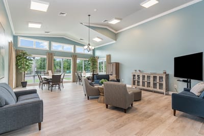 Bright common area with seating and large windows