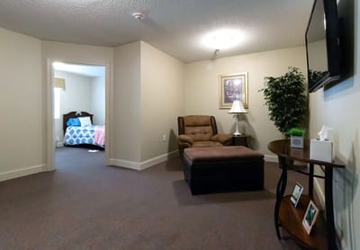 Cozy interior of a resident's room with a lounge chair