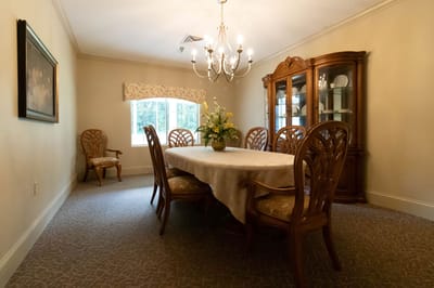 A well-furnished dining room with a large table and chairs