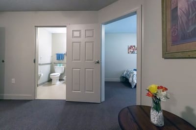 Private resident room with a bathroom and flowers