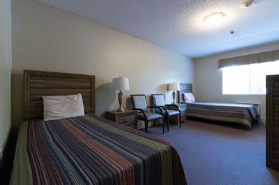 Cozy resident room with two beds and chairs