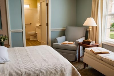 Cozy private resident room with a bed and chair