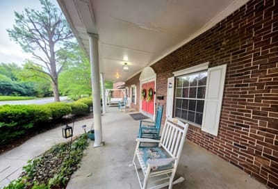 Rocking chairs on a covered porch outside