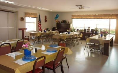 Interior of a dining room with tables set for residents