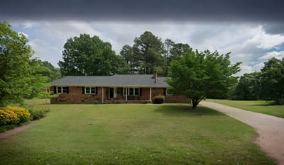 Exterior view of a residential facility with green grass and trees