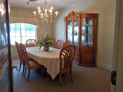 A dining room with a large table and china cabinet