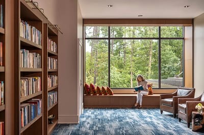 Resident reading in a cozy library corner