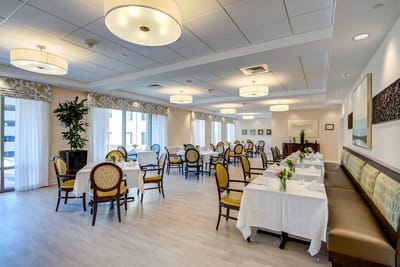 Bright dining room with tables set for meals