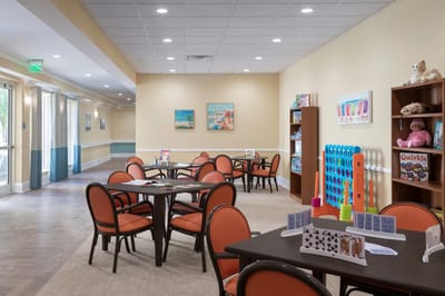 Bright common area with tables and chairs for activities