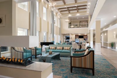 Bright and inviting common area with seating and piano