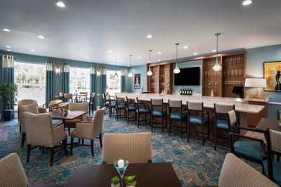 Bright dining area with a bar and seating