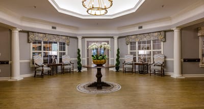 Brightly lit common area with seating and decorative plants