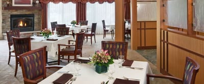 Bright dining room with tables set for meals