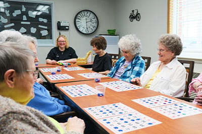 PRAIRIE WINDS Assisted Living, assisted living in Doniphan, NE — Seniors enjoying a bingo game in a recreational room