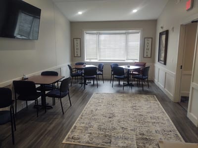 Interior activity room with tables and chairs