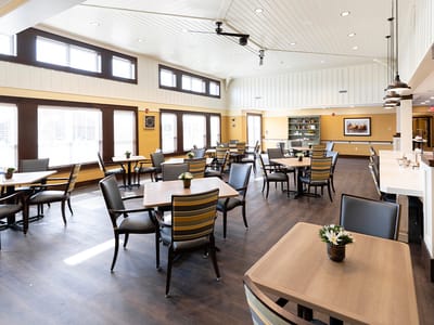 Bright dining room with tables set for residents