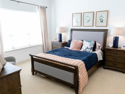 Brightly decorated private resident room with a bed and decor