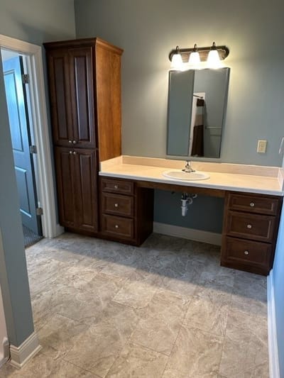 A well-lit interior bathroom with wooden cabinetry