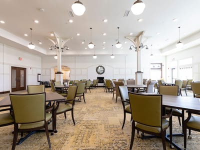 Bright common area with dining tables and chairs