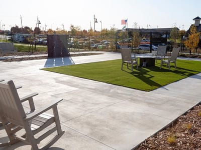 Outdoor seating area with rocking chairs and grass