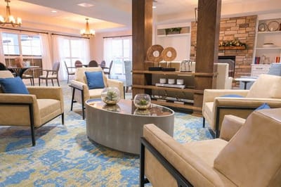Bright common area with comfortable seating and a fireplace